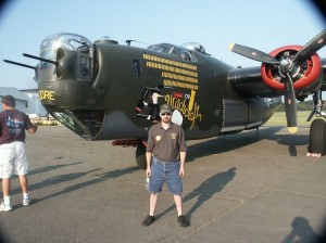 Eric M. Saperstein of Artisans of the Valley standing in front of the last flying B-24 Liberator