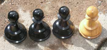 Chess Set Restoration - Three Black and One White Pawn - Chipped collars before restoration