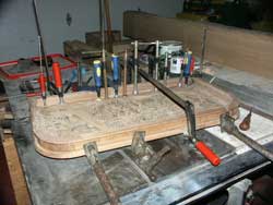 Hand carved bar lid in clamps during restoration
